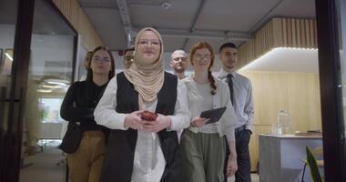 A diverse group of colleagues collaboratively and efficiently tackles various business tasks in a modern office, exemplifying teamwork, productivity, and a dynamic corporate environment. video