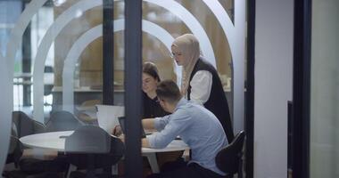 A diverse group of colleagues collaboratively and efficiently tackles various business tasks in a modern office, exemplifying teamwork, productivity, and a dynamic corporate environment. video