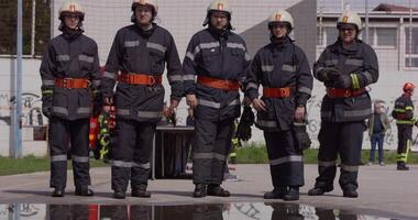 A specialized firefighting unit equipped with special attire and advanced equipment embarks on a hazardous fire suppression mission, showcasing their professionalism and readiness to combat fires in video