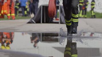 A team of firefighters swiftly readies water hoses, demonstrating their urgent response to prepare for a dangerous fire suppression mission, highlighting their commitment to firefighting and safety. video