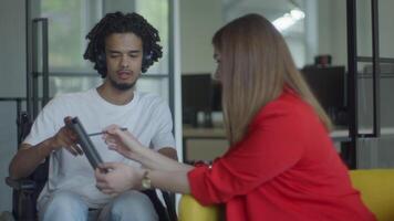 African American businessman in a wheelchair engages in a professional discussion with his colleague, addressing various business challenges and exploring solutions in an inclusive and diverse modern video