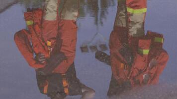 A group of prepared firefighters stands ready for hazardous tasks involving rescuing victims and extinguishing fires, exemplifying their dedication and bravery in the face of emergencies video