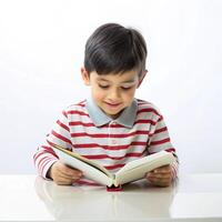 Cute a little boy writing a book on the table with on white background photo