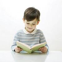 Cute a little boy writing a book on the table with on white background photo