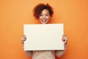 Happy Woman Holding Blank White Sign Against Orange Background photo