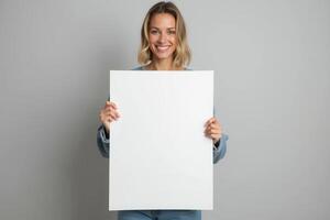 Smiling Woman Holding a Blank White Sign photo