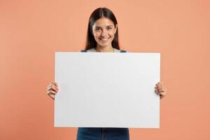 Smiling Woman Holding a Blank White Sign photo