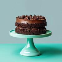 Chocolate Cake with Swirled Frosting on a Teal Cake Stand photo