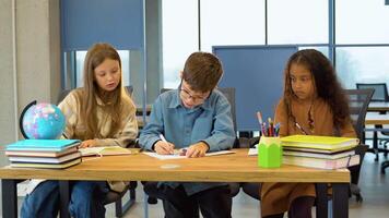 Pupils of elementary class doing homework. Kids learning to read and write. Back to school video