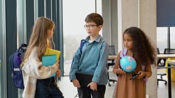 Three diverse pupils communicate in the class after the lesson video