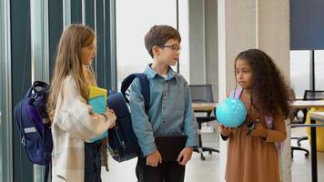 Three diverse pupils communicate in the class after the lesson video
