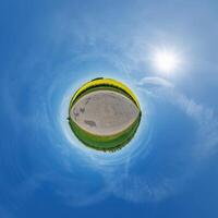 simple little tiny planet without buildings in blue sky with beautiful clouds. Transformation of spherical panorama 360 degrees. Spherical abstract aerial view. Curvature of space. photo