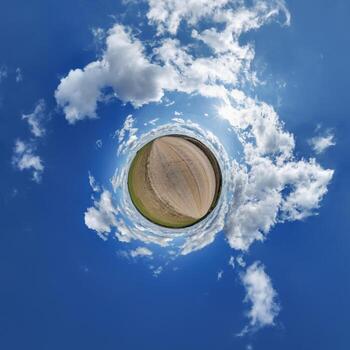 simple little tiny planet without buildings in blue sky with beautiful clouds. Transformation of spherical panorama 360 degrees. Spherical abstract aerial view. Curvature of space. photo