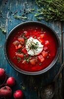 Borscht is a red beet soup with vegetables, served with sour cream in a bowl photo