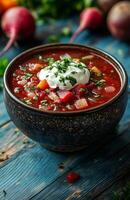 Borscht is a red beet soup with vegetables, served with sour cream in a bowl photo