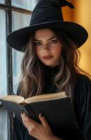 A stunning witch in black attire, holding a magical book, yellow background photo