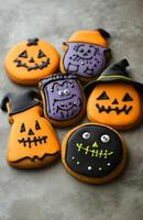Halloween character cookies on a grey background, colorful and creatively decorated, various spooky faces photo