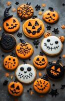 Halloween character cookies on a grey background, colorful and creatively decorated, various spooky faces photo