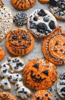 Halloween character cookies on a grey background, colorful and creatively decorated, various spooky faces photo
