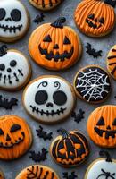Halloween character cookies on a grey background, colorful and creatively decorated, various spooky faces photo