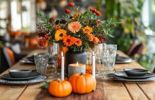 Autumn table setting featuring pumpkins, candles, and flowers on a wooden surface for festive decor photo