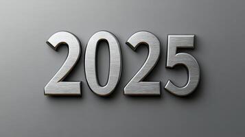 Elegant 2025 in silver serif font on a smooth gray background. photo