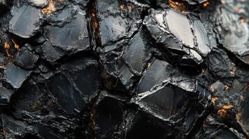 Polished tektite with a dark, glossy finish, displayed in a close-up shot that emphasizes its natural texture and reflective properties. photo