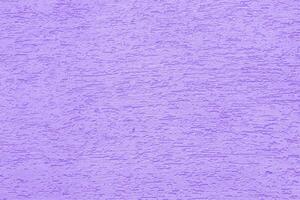 Violet plaster wall of a building. Rough surface texture. photo