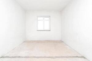 Empty white room without renovation with one window. photo