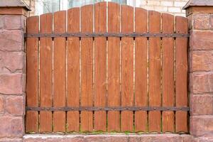 Vintage fence of old wooden boards. Texture of an aging wooden surface. Beautiful wooden background. photo
