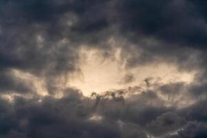 Dark gloomy clouds on a stormy sky. Natural atmospheric background. photo