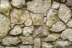 Wall of gray stones. Stone building background. photo