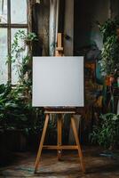 Blank canvas standing on easel in an art studio waiting for a painter photo