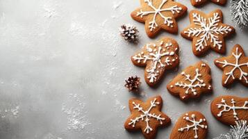 Christmas gingerbread cookies decorated with icing on grey background with fir branches photo