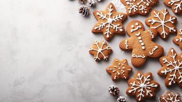 Christmas gingerbread cookies decorated with icing on grey background with fir branches photo