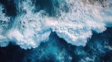 Big waves crashing creating white foam on water surface aerial view photo