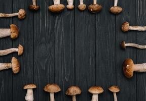 Autumn Cep Mushrooms. Basket with porcini mushrooms on the background of a tree outdoors. Close -up on wood rustic table. Cooking delicious organic mushroom. photo