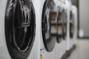 Rows of modern washing machines in a store photo