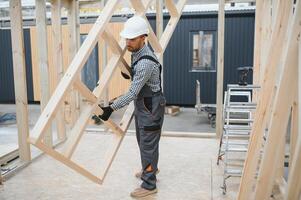 Process of construction new and modern modular house. Worker man in special protective uniform wear working on building development industry of energy efficient property photo