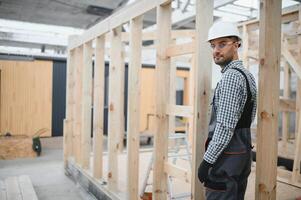 Process of construction new and modern modular house. Worker man in special protective uniform wear working on building development industry of energy efficient property photo