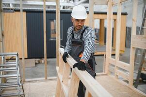Process of construction new and modern modular house. Worker man in special protective uniform wear working on building development industry of energy efficient property photo