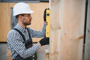 Process of construction new and modern modular house. Worker man in special protective uniform wear working on building development industry of energy efficient property photo