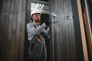 Process of construction new and modern modular house. Worker man in special protective uniform wear working on building development industry of energy efficient property photo