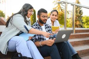 Group of smiling multiethnic near university campus photo