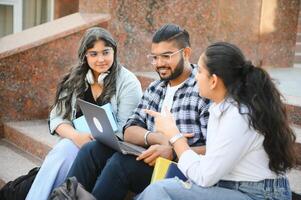 Group of smiling multiethnic near university campus photo