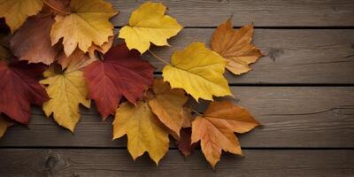 Autumn leaves on rustic wooden background. photo