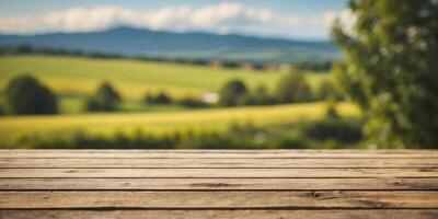 an empty wood table top with countryside landscape background. photo