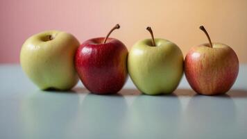 Row of colorful apples on a pastel background. photo