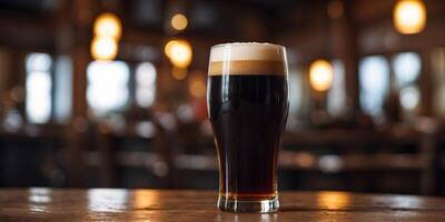 Refreshing dark beer in a tall glass on a rustic pub table. photo
