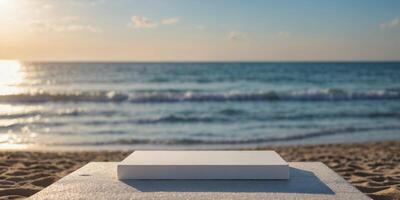 Empty white square shaped podium with beach in blurry background. photo